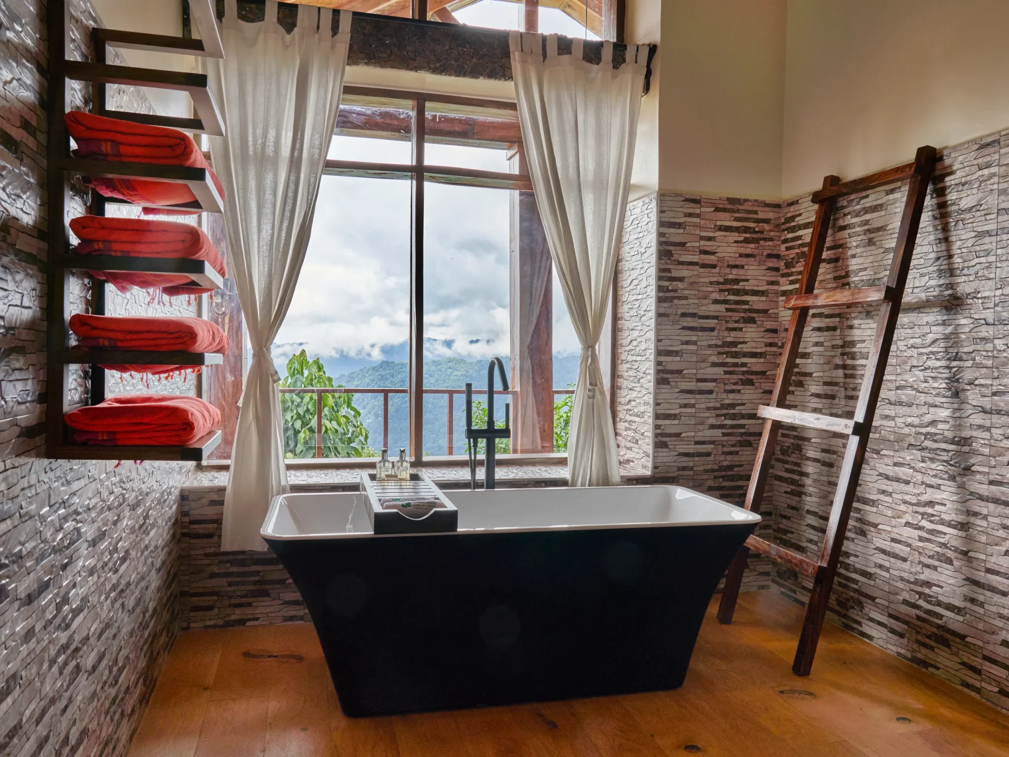 Nkuringo Gorilla Lodge luxury forest suite bath with mountain view