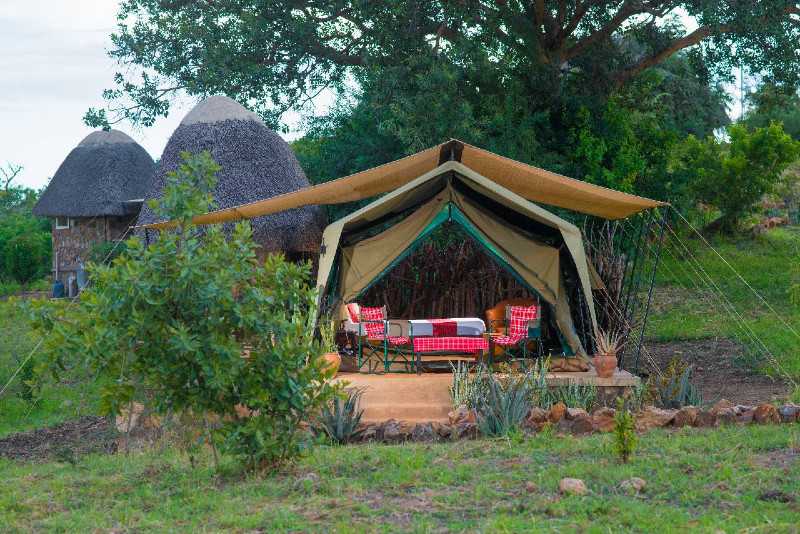 Safari tent and thatched buildings at Kidepo Savannah Lodge