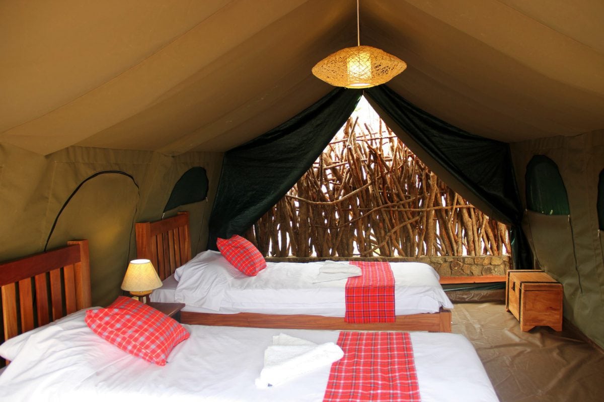 Double and single beds inside a Kidepo Savannah Lodge safari tent