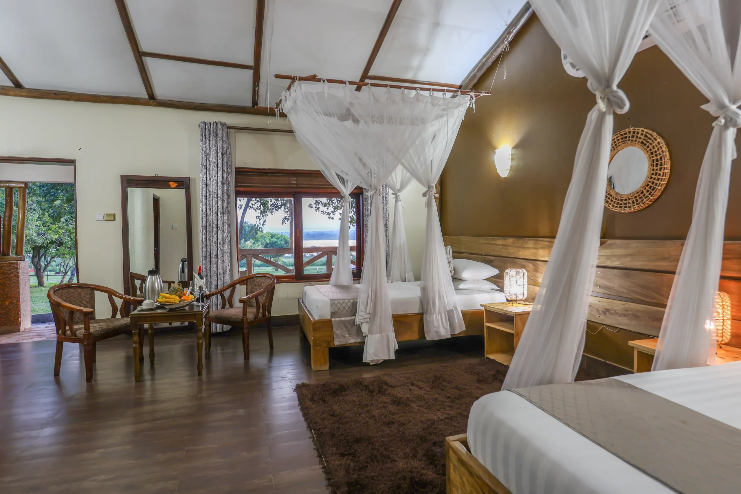 Safari lodge family room with several beds under mosquito nets