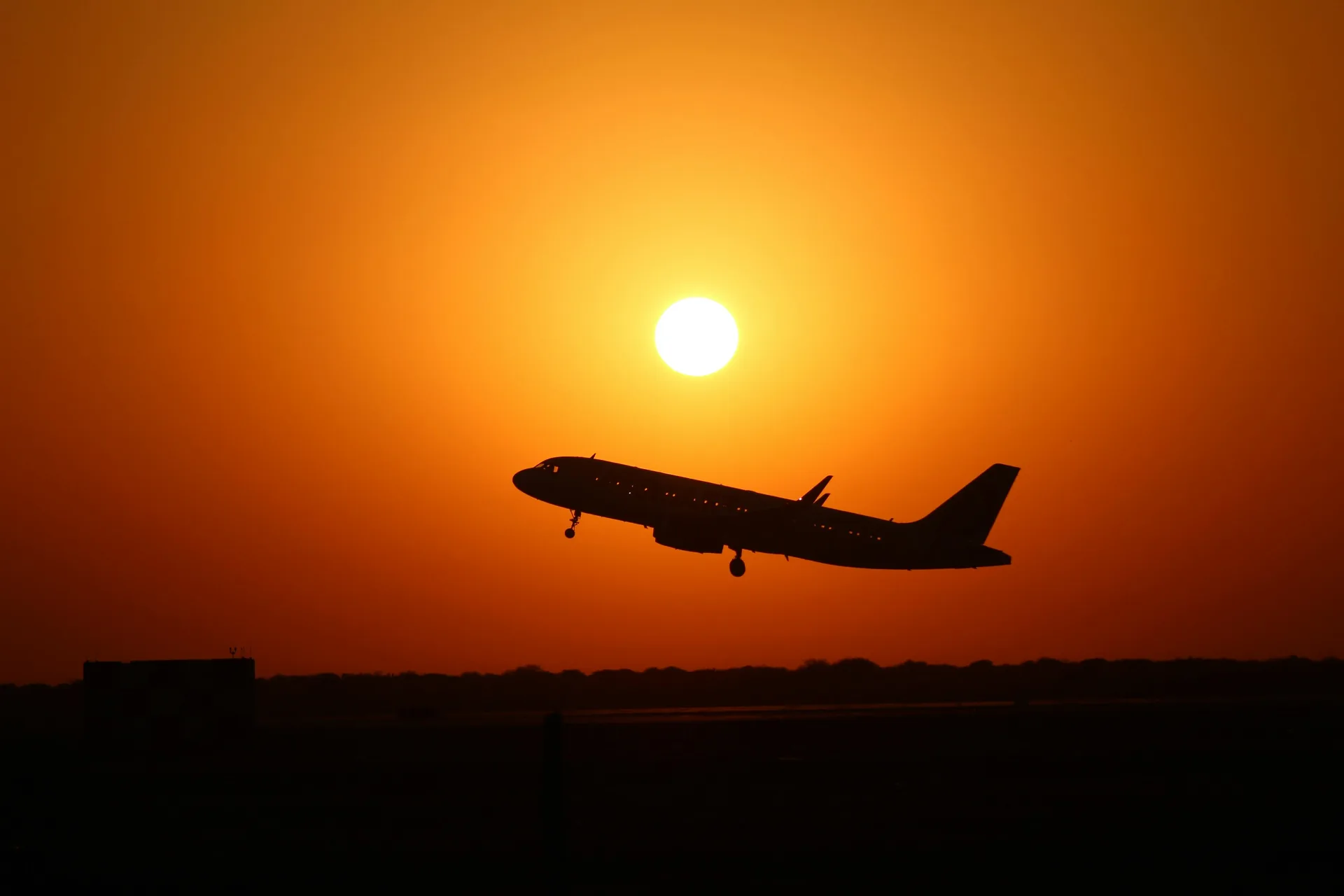 Passenger aircraft departing at sunset
