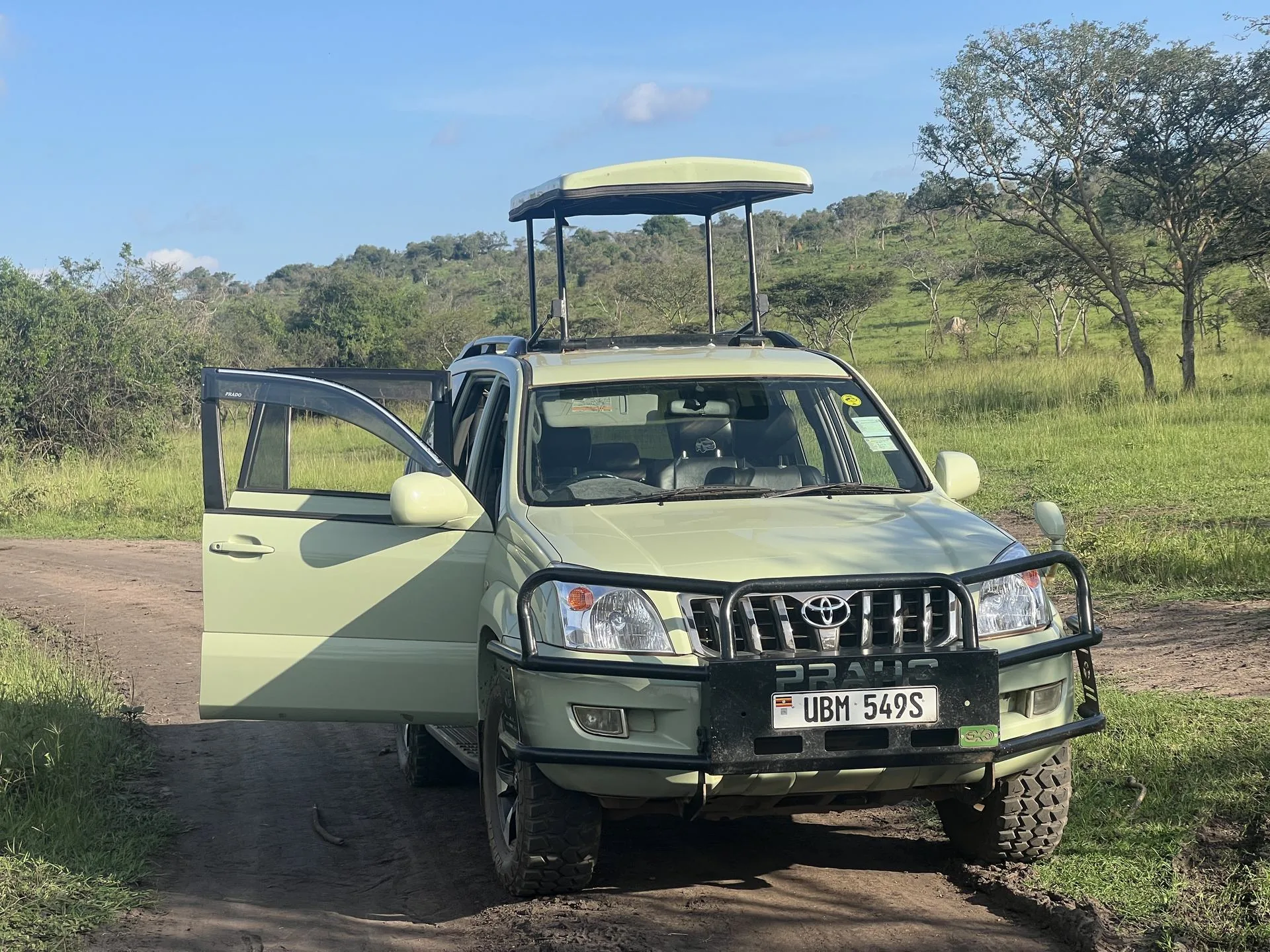 Private Uganda safari vehicle positioned in a wildlife landscape